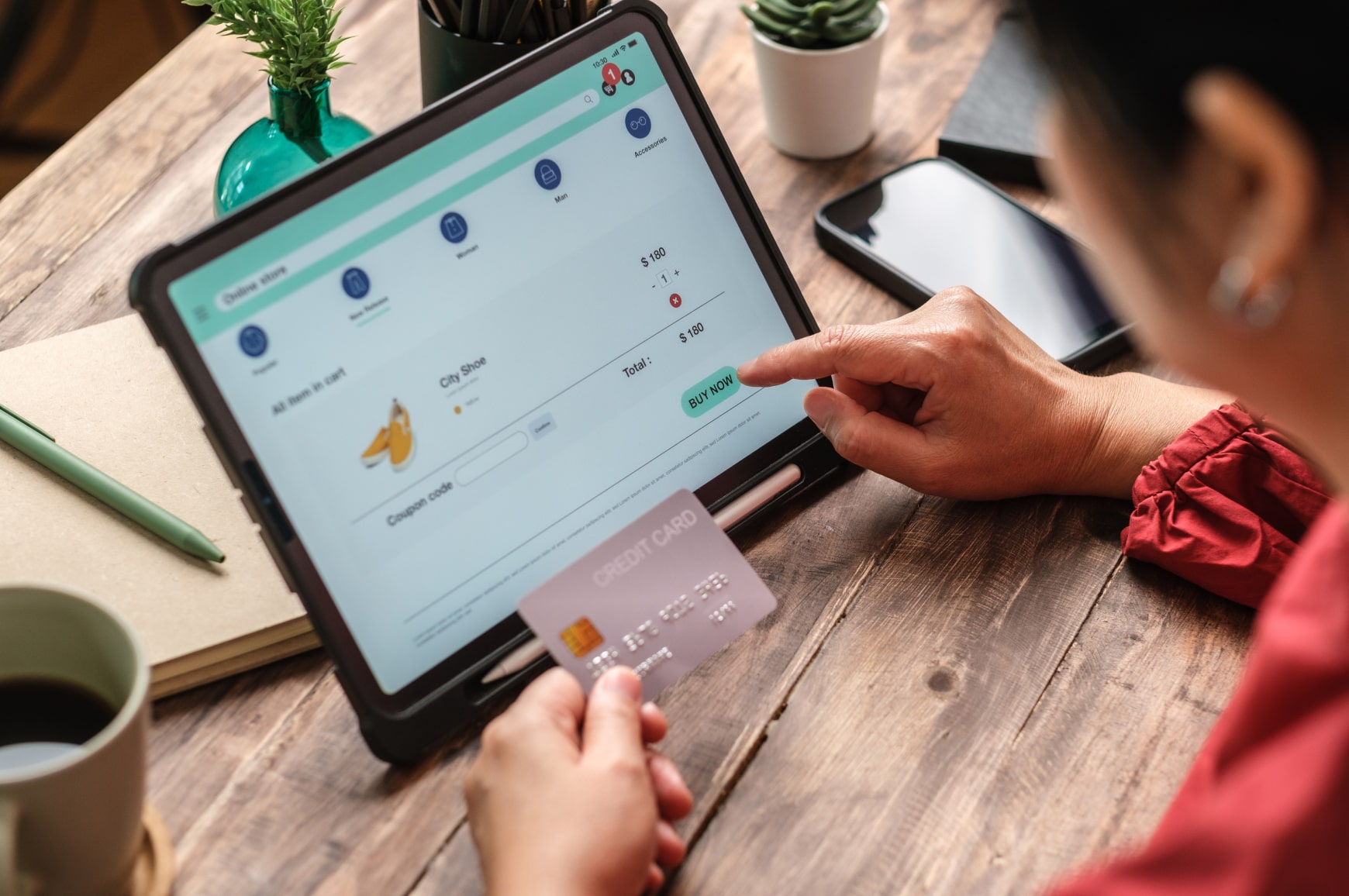 A customer making an online purchase on a tablet using a credit card, showcasing a seamless checkout process.