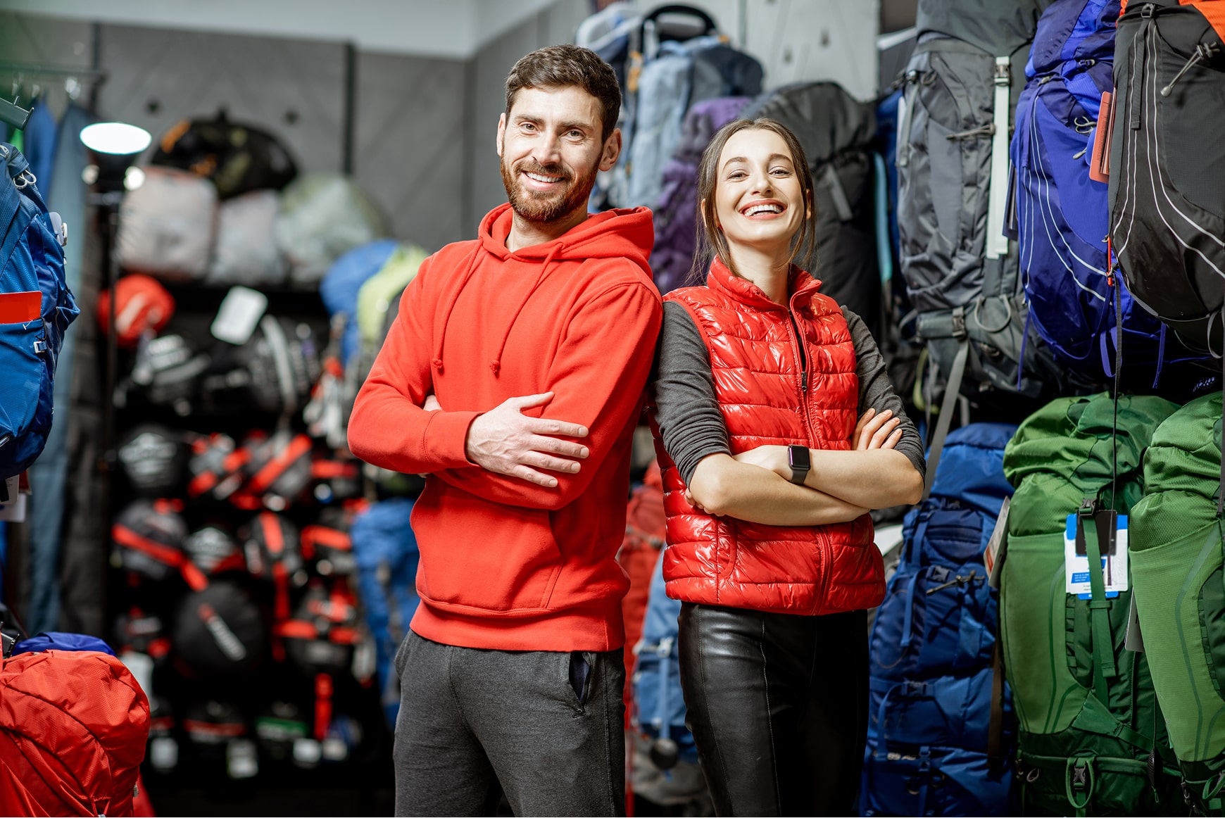 A caucasian couple standing in an outdoor gear shop.