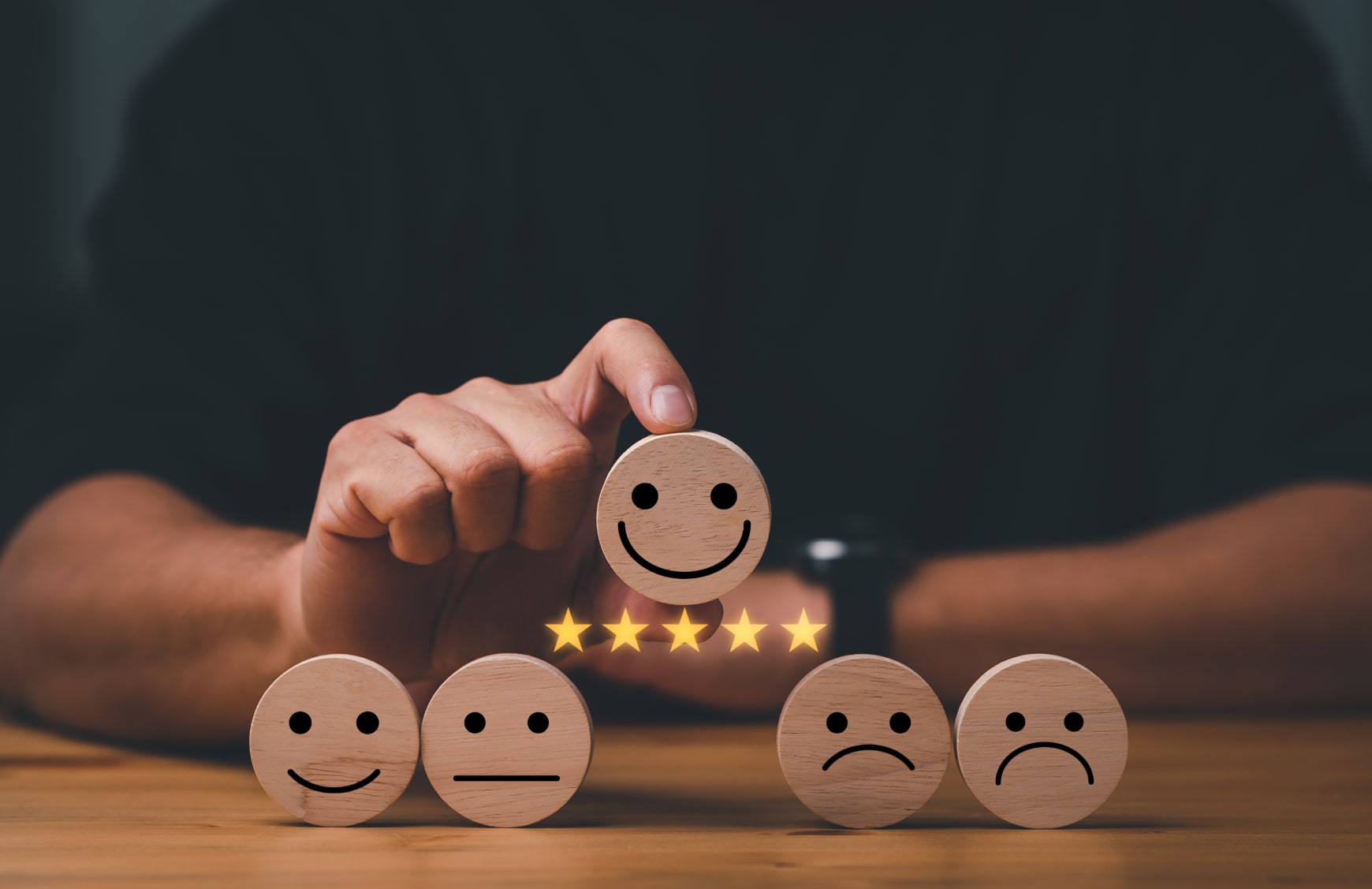A man selecting a five star rating after a successful online user experience