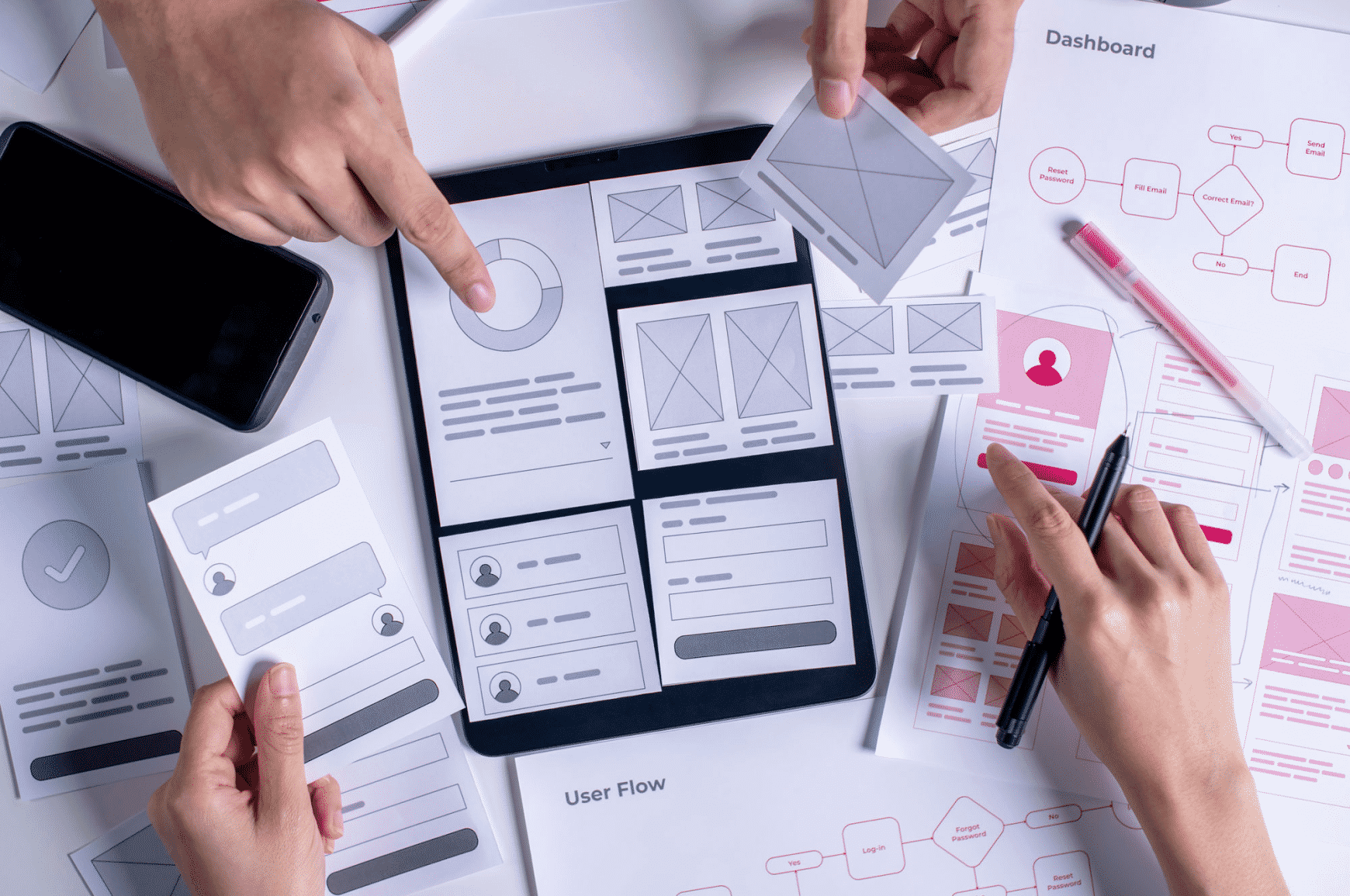 People collaborating on UX and UI of a site with paper sections